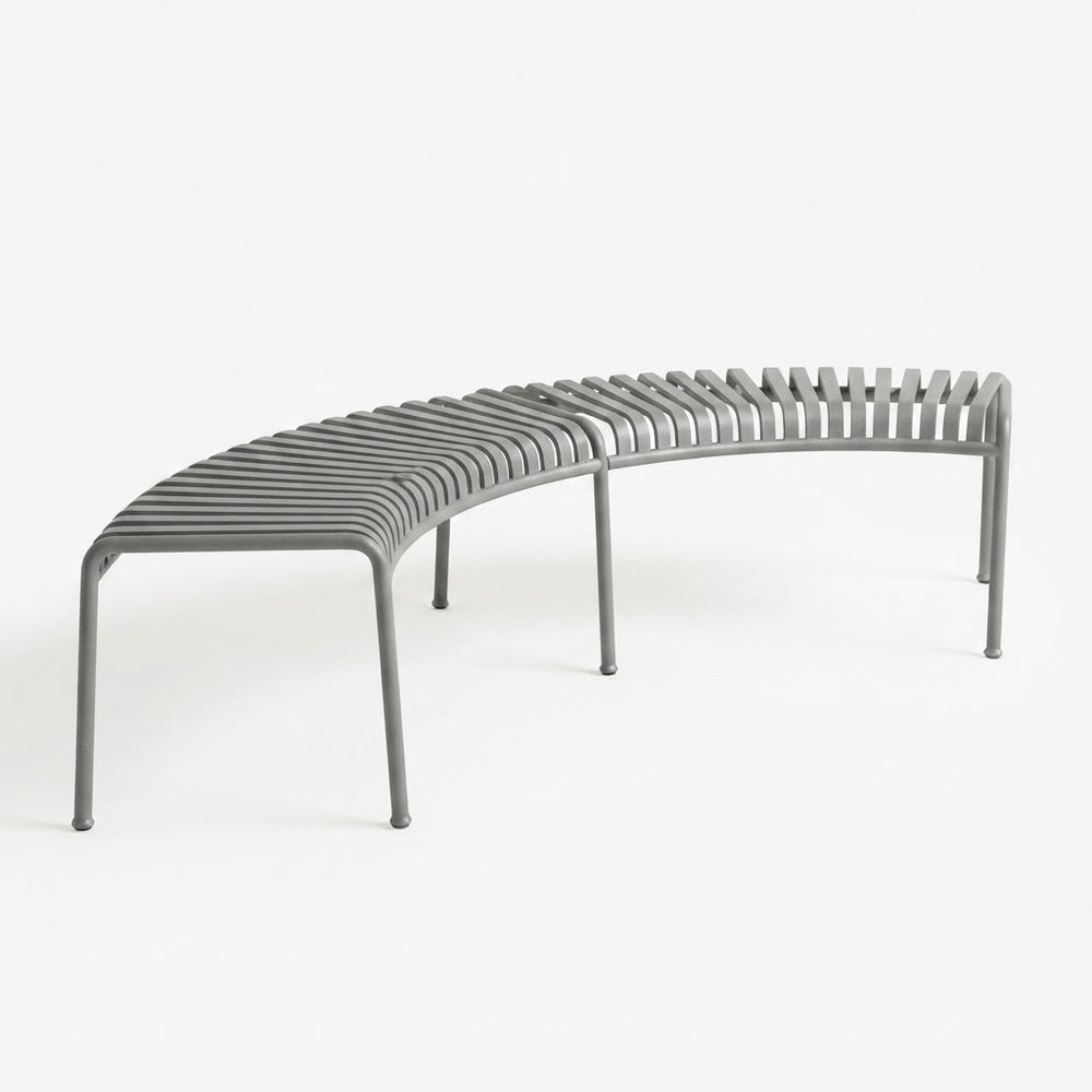 A curved gray metal bench with a slatted seat and backrest, shown on a clean white studio background.