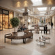 A modern curved wooden bench with dark metal armrests in a spacious, upscale shopping mall atrium. Several people are seated on the bench and nearby round tables, with other shoppers and storefronts visible in the background.