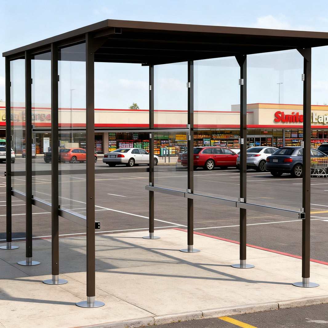 Side profile of modern shopping cart shelter featuring flat roof design and transparent glass enclosure.