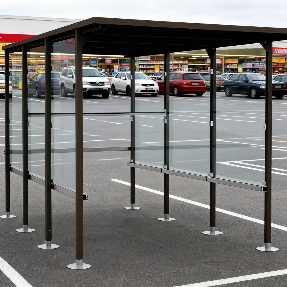 Rear angle of shopping cart shelter with flat roof and full glass back panel.