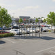 Empty modern shopping cart shelter with flat roof and glass enclosure designed for grocery and retail stores.