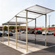 TAIMCO shopping cart shelter installed outdoors with curved polycarbonate roof and steel frame.