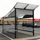 Close‑up of wavy perforated metal roof on TAIMCO shopping cart shelter showing modern weather‑resistant design.