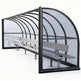 TAIMCO referee shelter installed beside a sports field with curved roof and aluminum bench.