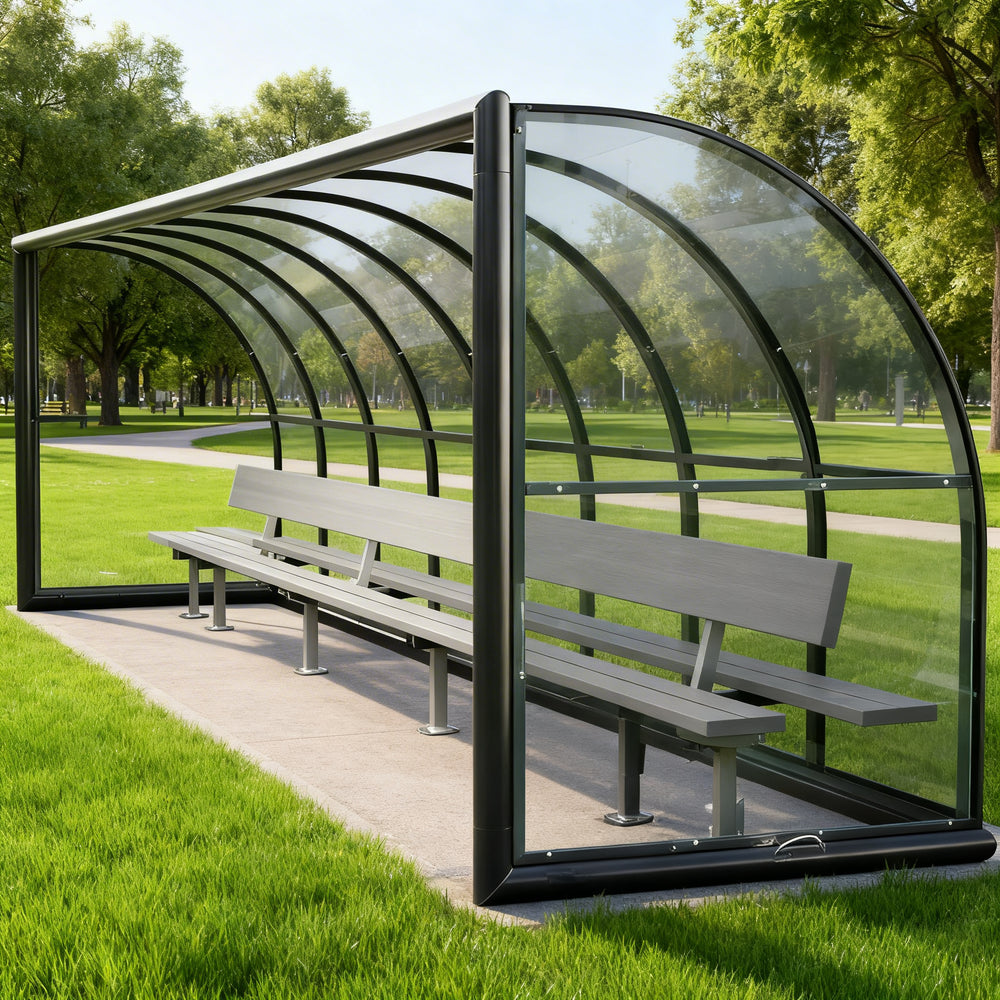 Rear angle of sports field shelter with curved roof and clear back panel.