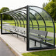 Side profile of sports field referee shelter featuring curved roof and transparent side panels.