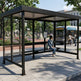 Rear angle of bus stop shelter with flat roof and full glass back panel.