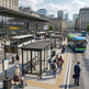 Tempered glass side panel on TAIMCO bus stop shelter offering visibility and weather protection.