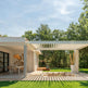 Louvered pergola casting patterned shadows on patio surface