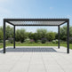 Louvered pergola casting patterned shadows on patio surface