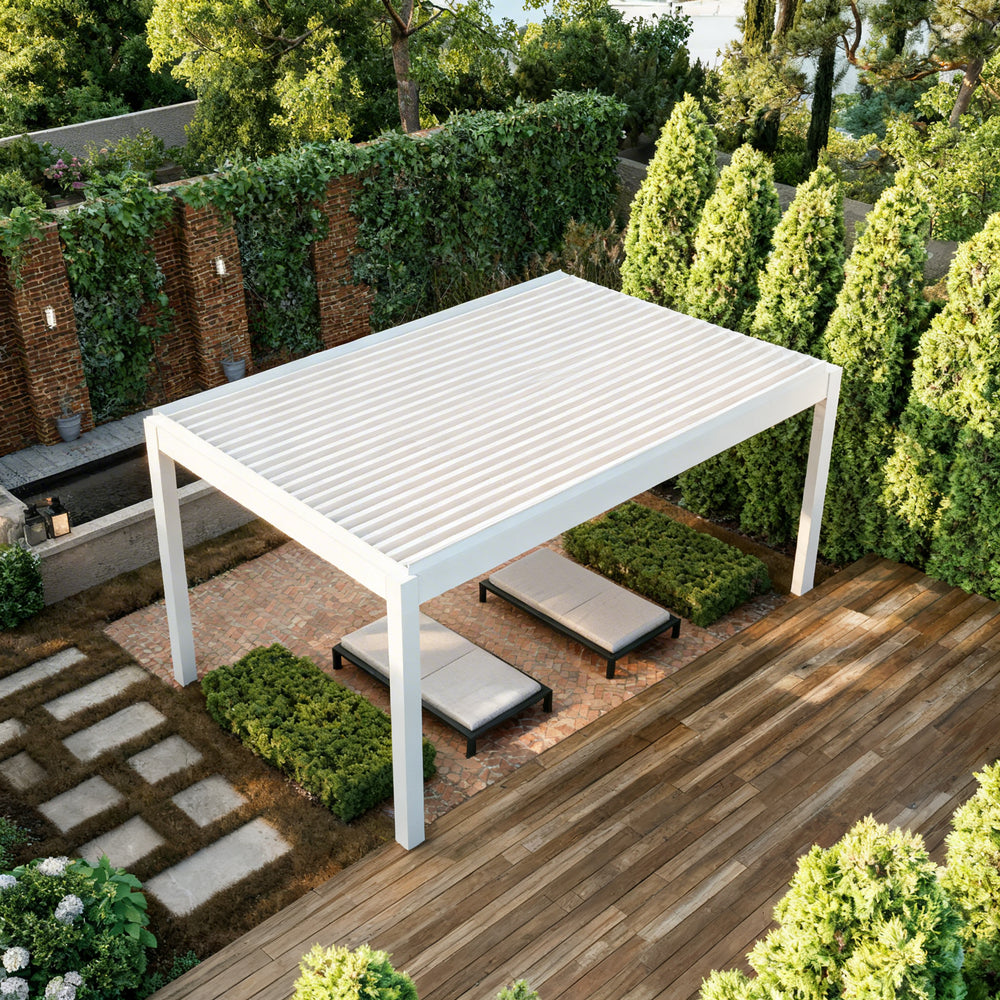 White outdoor pergola with seating area in a garden setting