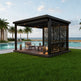 Modern outdoor gazebo with seating area by a pool and ocean view
