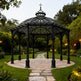 Ornamental pergola with Gothic arches and decorative finial.