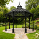 Ornamental pergola with Gothic arches and decorative finial.
