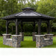 Hexagonal gazebo with stone foundation in a park setting