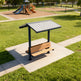 Front view of compact steel shelter with built‑in seating