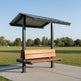 Side angle of square gable‑roof micro pavilion with benches