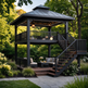 A two-story outdoor gazebo with a dark metal roof and railing, featuring an attached staircase, a lower patio seating area with a coffee table and cushions, and a lush green garden background.
