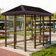 Empty modern bus stop shelter with slanted roof and glass enclosure designed for public transportation stops.