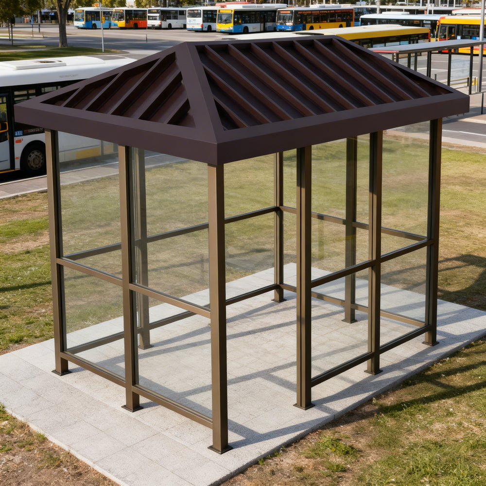 Tempered glass side panel on TAIMCO bus stop shelter providing visibility and weather protection.