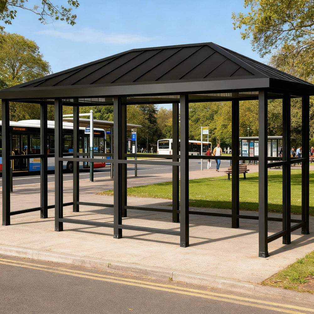 Side profile of modern bus stop shelter featuring hip‑top roof design and transparent glass enclosure.