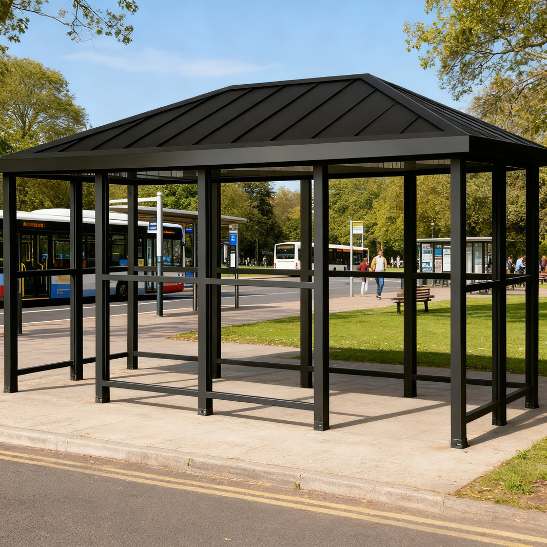 Side profile of modern bus stop shelter featuring hip‑top roof design and transparent glass enclosure.
