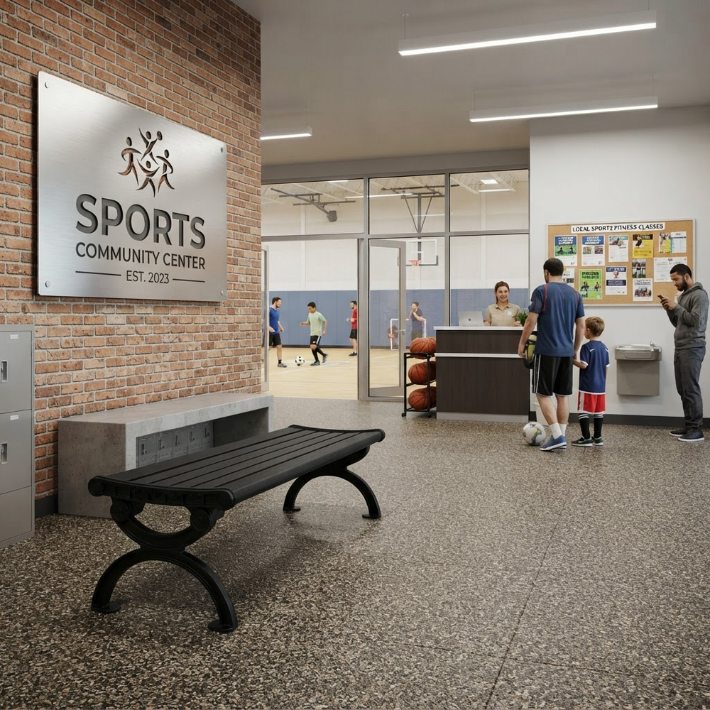 A modern sports community center lobby with a brick wall, a large 'SPORTS COMMUNITY CENTER' sign, a black bench in the foreground, and people gathered near a reception desk in the background.