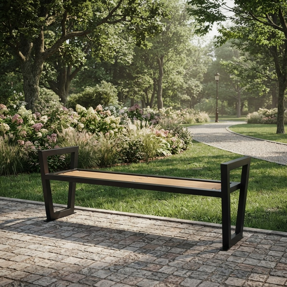 A modern bench with a light wood seat and dark metal frame, positioned on a stone pathway in a lush, green park with flowering bushes and a winding path in the background.