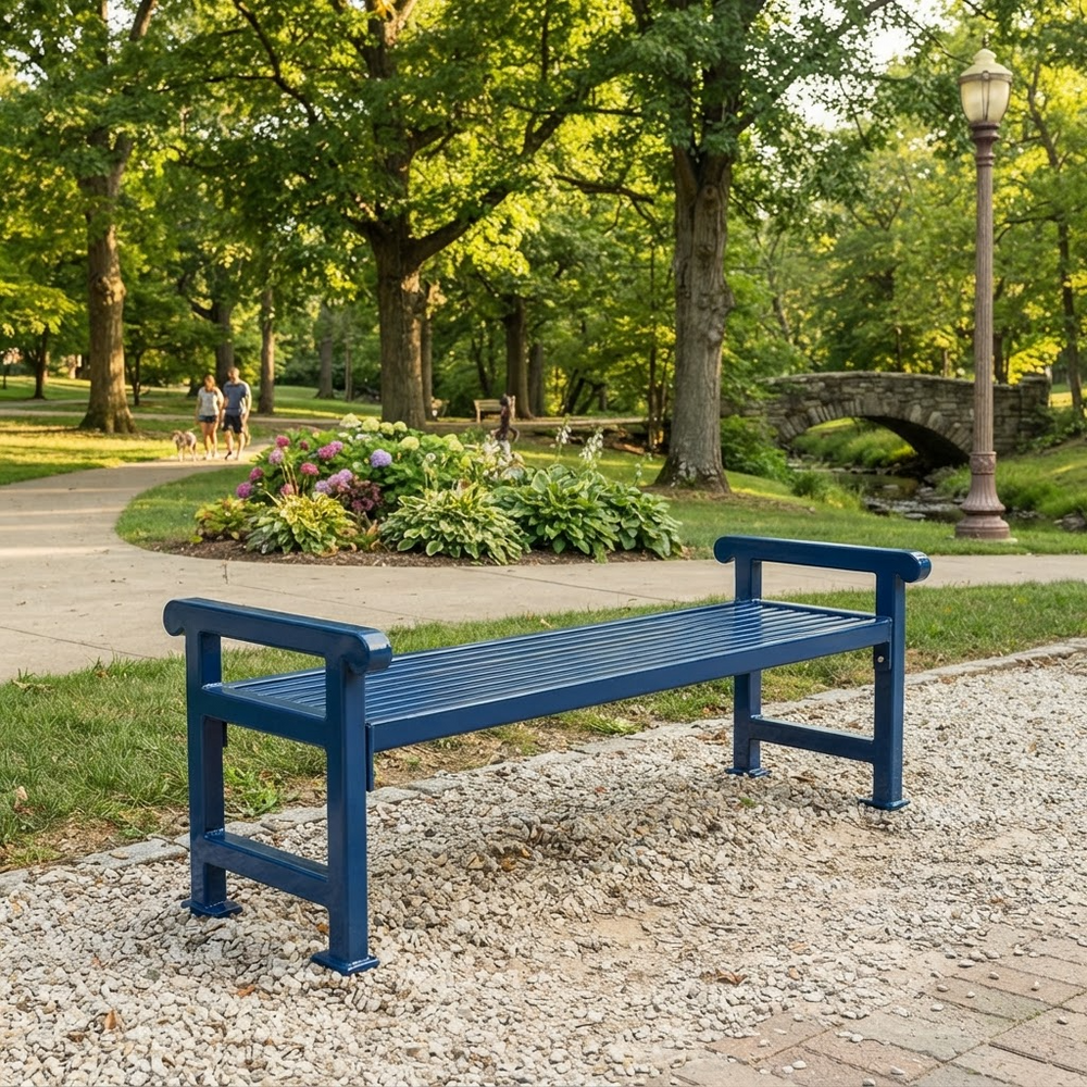 A dark blue slatted outdoor park bench placed on a gravel path in a sunny, tree-filled park with a stone bridge and lamppost in the background.