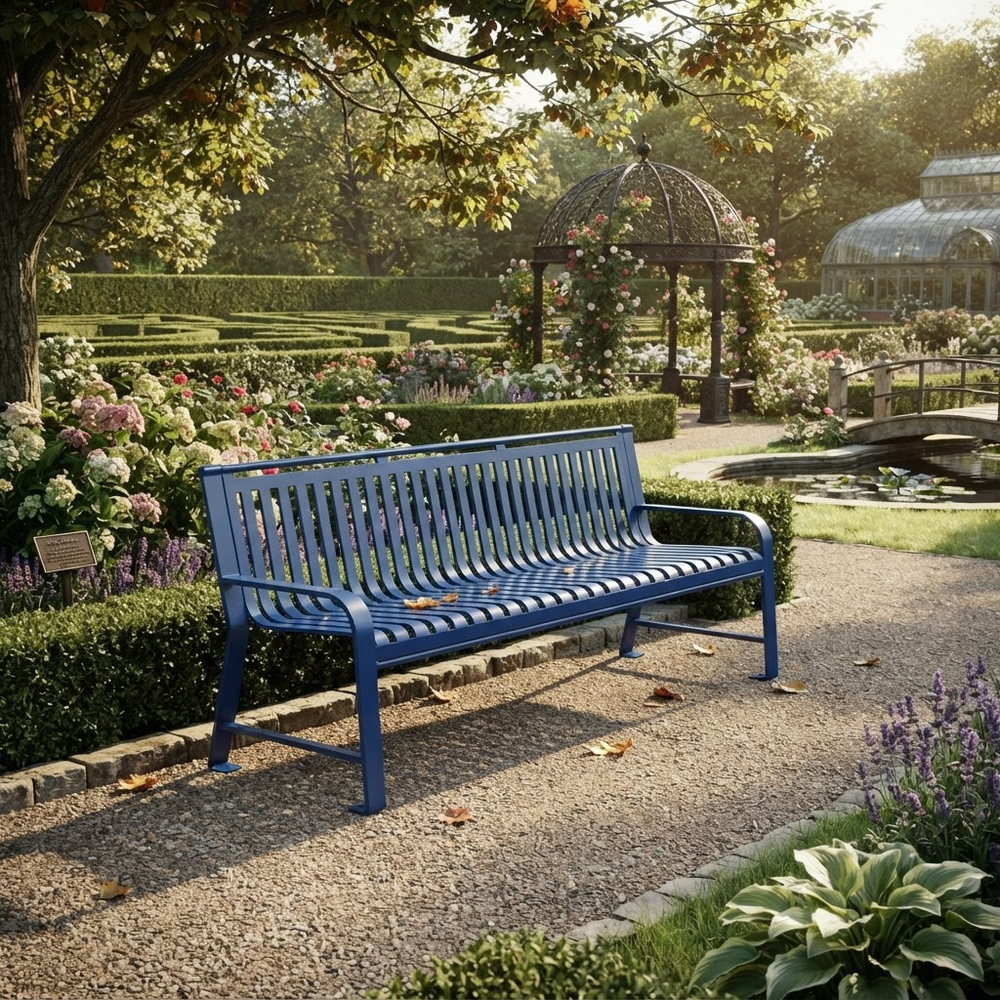 A blue metal garden bench sits on a gravel path in a beautifully landscaped park with hedges, flowers, trees, and a gazebo in the background.