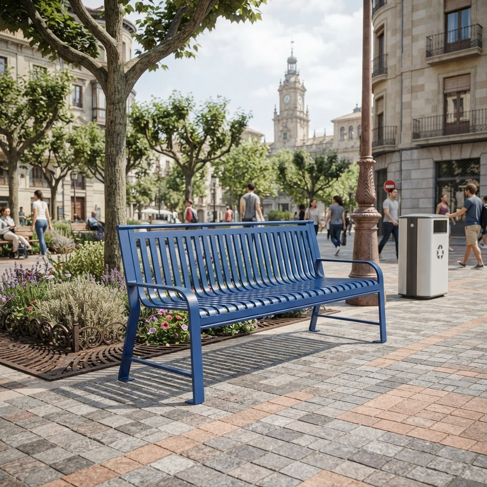 A blue slatted metal park bench in a paved urban plaza with trees, buildings, pedestrians, and a trash can in the background.