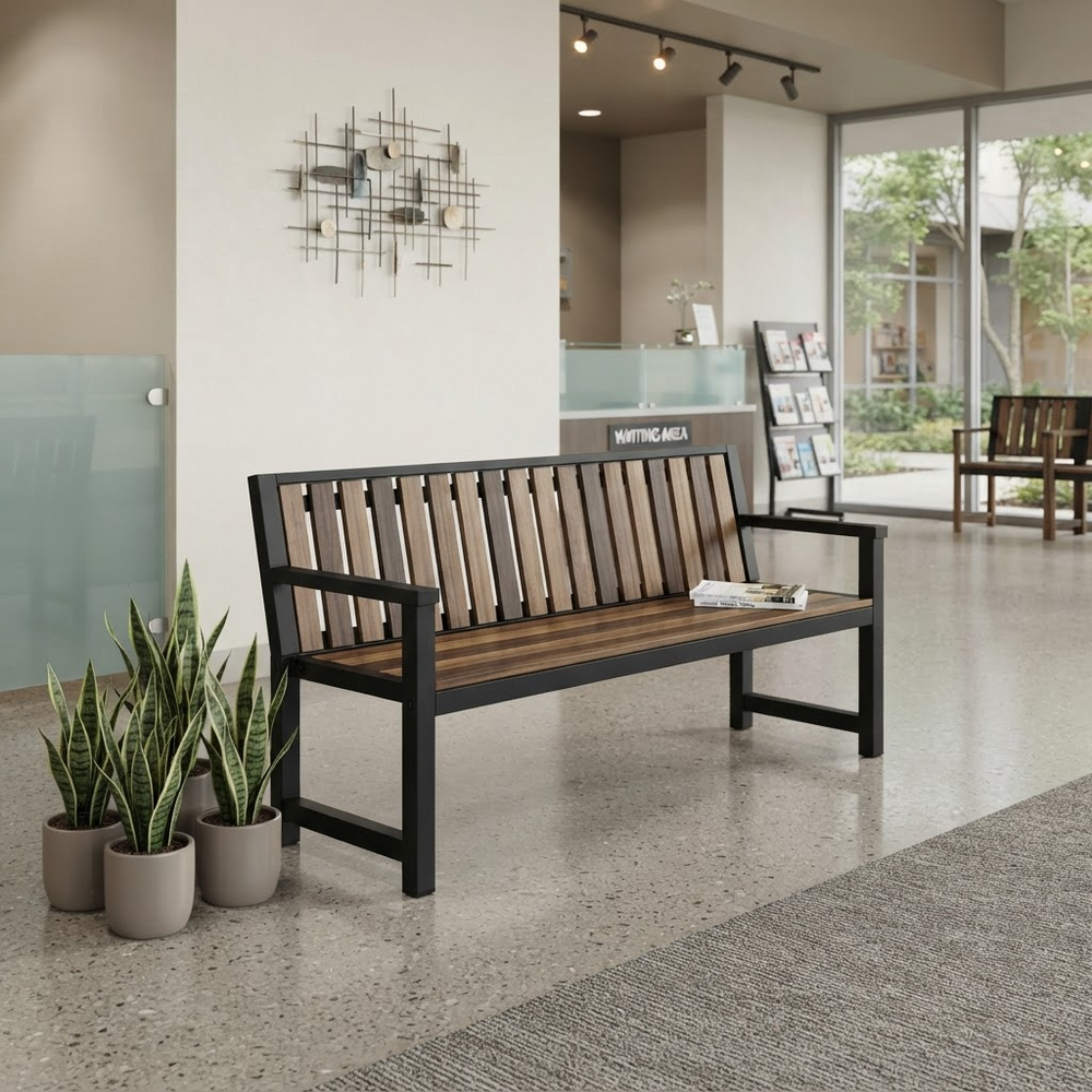 A modern outdoor-style bench with a black metal frame and brown wooden slats, placed in a clean indoor lobby setting with potted plants nearby.
