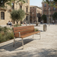 A modern outdoor wooden park bench with a silver metal frame, situated in a sunny urban plaza with people sitting in the background.