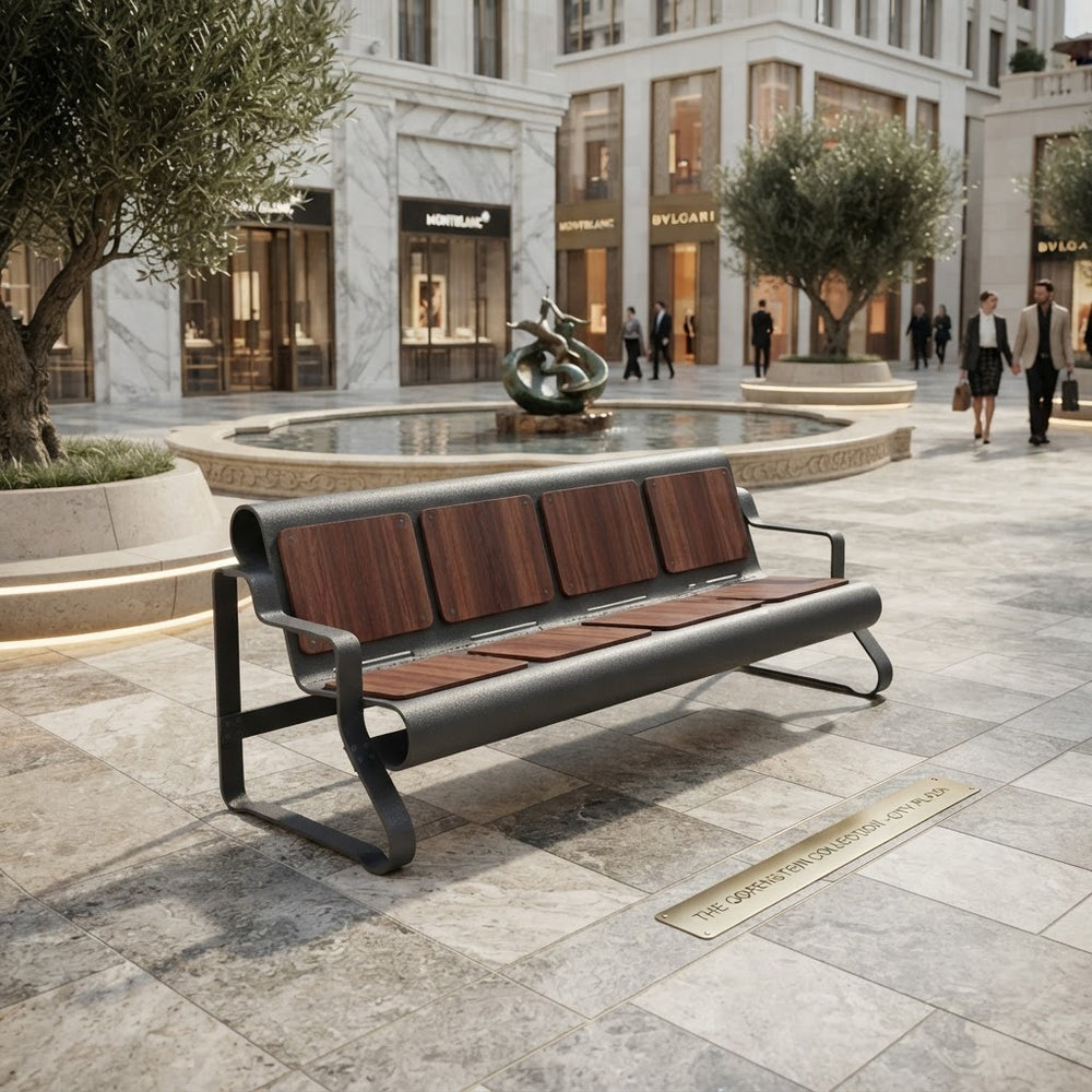 A modern outdoor bench with dark metal framing and brown wood-look seat and back panels, placed in a upscale plaza with stone tiles, trees, a fountain, and buildings in the background.