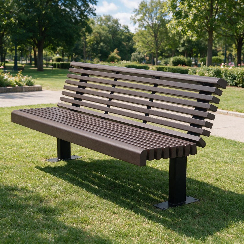 A modern outdoor park bench with dark brown slatted seat and backrest on black metal legs, situated on a green grassy lawn in a sunny park setting.