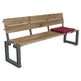 A wooden park bench with a rustic light brown wood slat back and seat, supported by a dark gray metal frame, featuring a red tufted cushion on the right side.