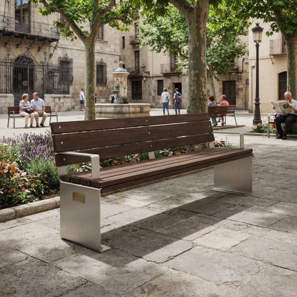 A modern outdoor park bench with dark brown wooden slats and brushed silver metal supports, situated in a sunny stone plaza with trees, historic buildings, and people sitting in the background.
