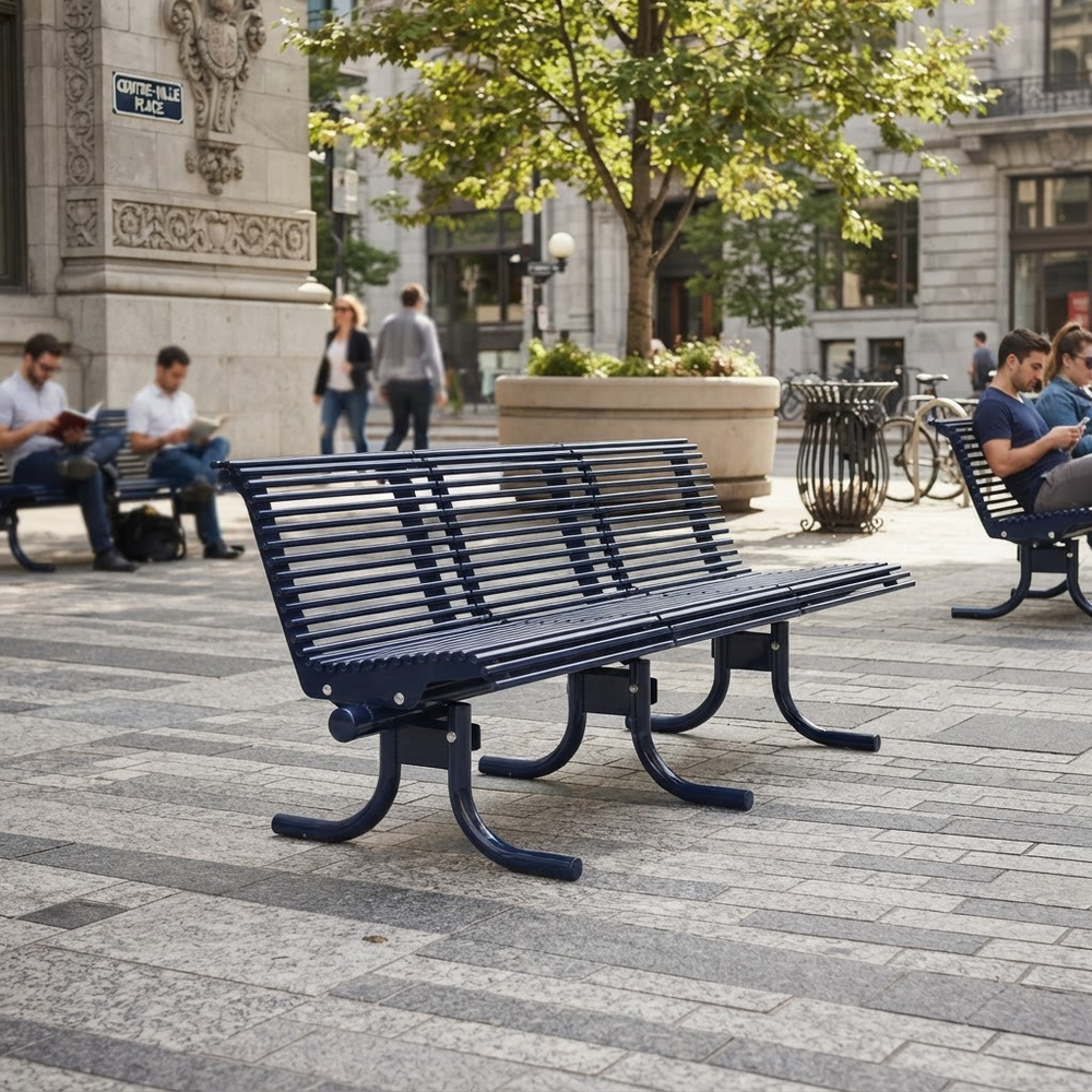 A dark navy blue slatted park bench in a city plaza, with people sitting on other benches and trees in the background.