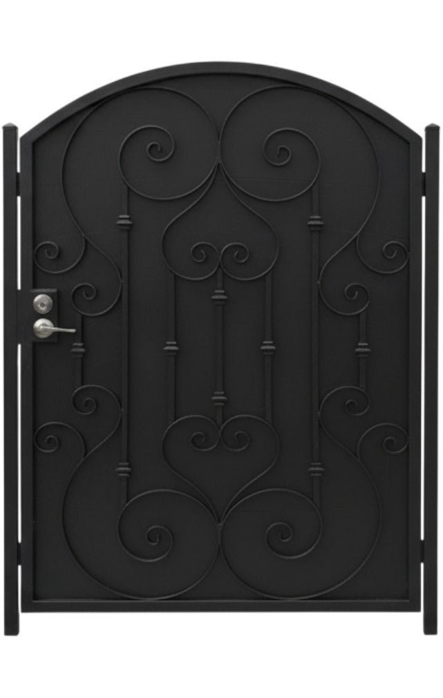 Heartspire Passage – Ornamental wrought iron man door with heart-scroll lattice, arched crown, and symmetrical floral accents Model # MG315