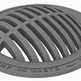 Round gray cast iron manhole cover with a grid pattern and text inscription.