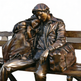 Bronze sculpture of a couple sitting on a bench