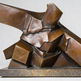 Textured metal sculpture with angular geometric shapes and contemporary abstract design