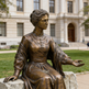 Historical bronze sculpture of Catherine McAuley sitting gracefully on a stone bench