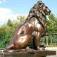 Majestic bronze lion statue in a seated pose with realistic texture and craftsmanship