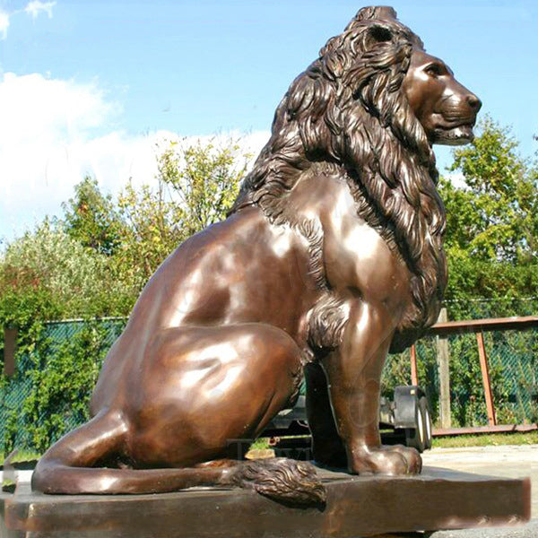 Majestic bronze lion statue in a seated pose with realistic texture and craftsmanship