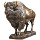Bronze statue of a bison on a white background