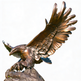 Bronze statue of an eagle with outstretched wings on a white background