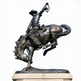 Bronze western sculpture of a cowboy balancing on a bucking horse with expressive movement.