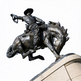 Bronze statue of a rodeo cowboy riding a bucking horse, showcasing strength, motion, and craftsmanship