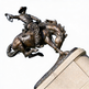 Dynamic bronze statue of a cowboy atop a rearing horse, capturing motion and rodeo energy